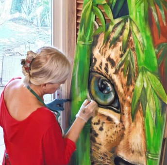 Albina painting in her studio